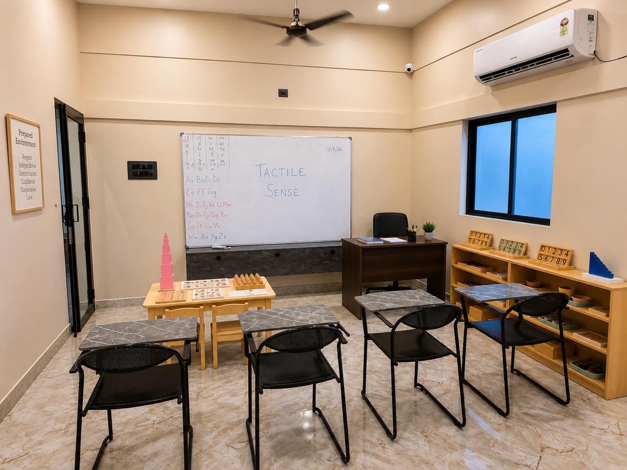 Montessori training classroom at IMTTI Medavakkam with pink tower, sensorial materials and a whiteboard lesson on tactile sense