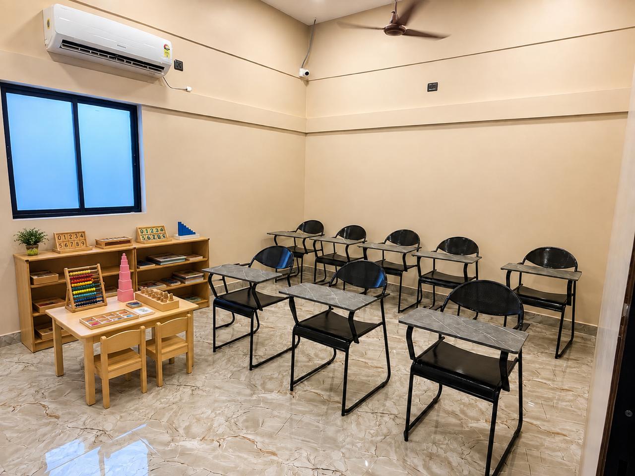 Prepared Montessori environment with shelves of number cards, abacus, pink tower and child-sized furniture at the Chennai centre