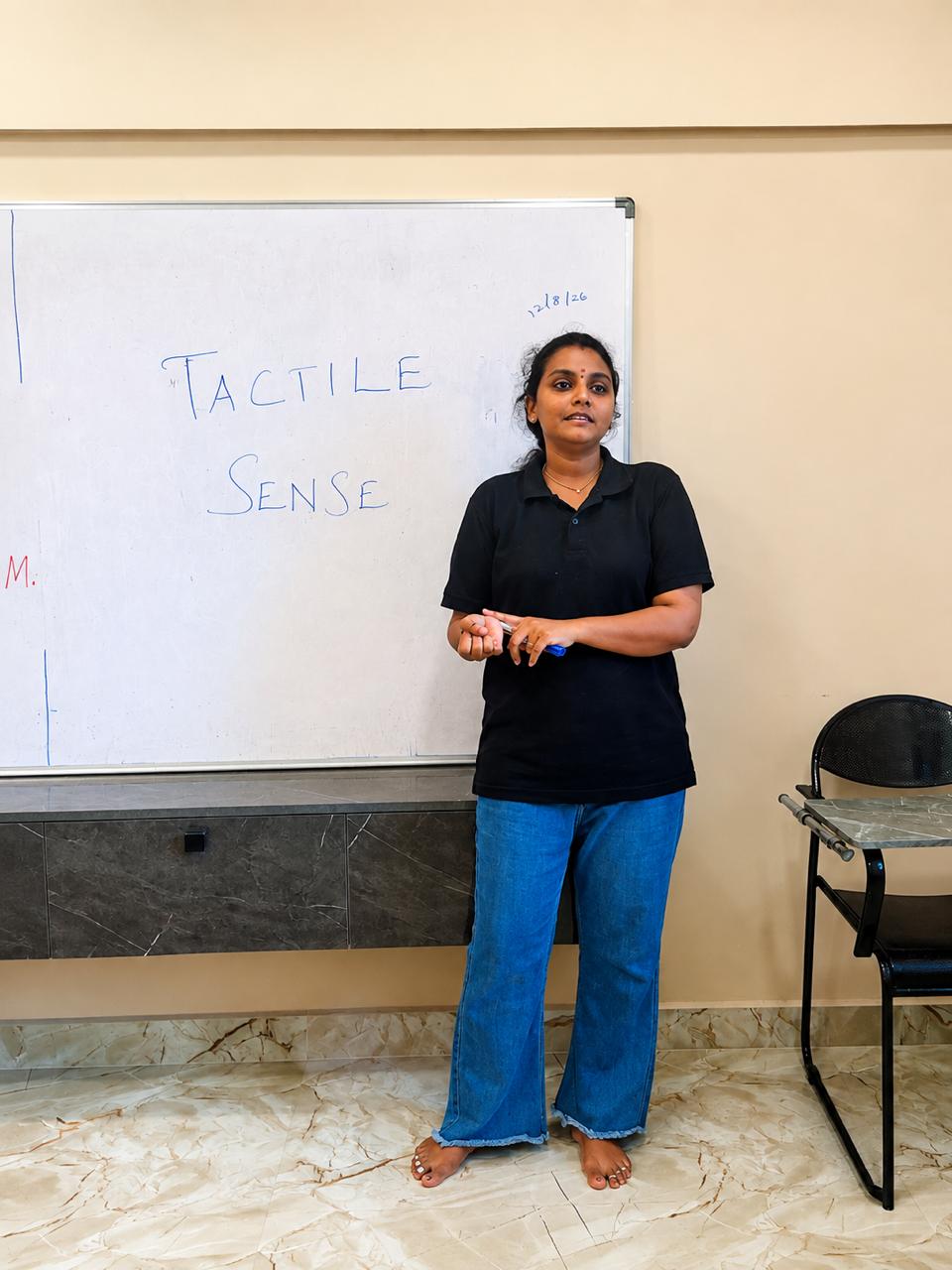 Trainee teacher presenting a tactile sense lesson during a Montessori training session