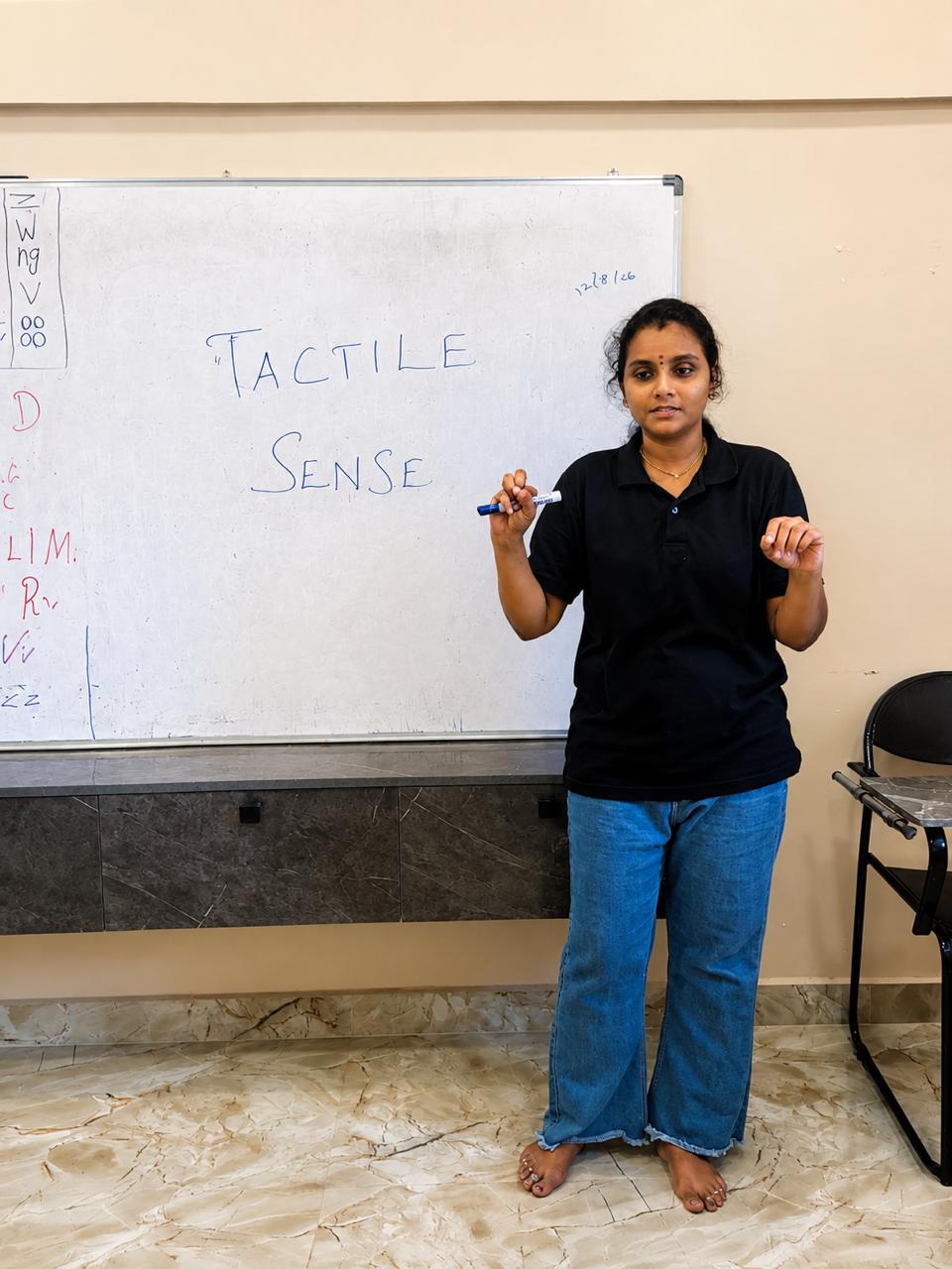 Montessori trainee demonstrating a sensorial presentation at the whiteboard during practical training